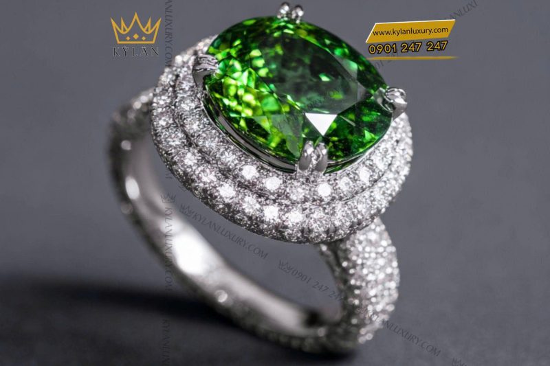 Nhẫn nữ vàng trắng nguyên khối Au750 đính viên chủ đá xanh