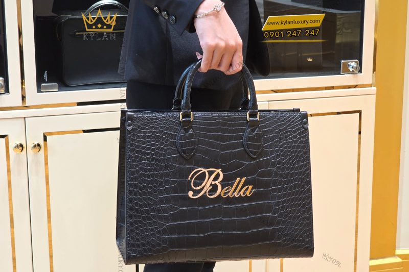 Túi xách nữ full da cá Alligator black đính logo chữ Bella vàng Au750