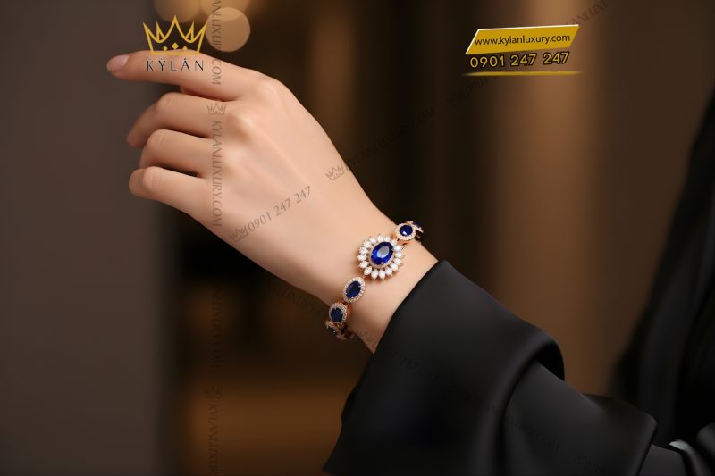 Lắc tay vàng hồng Au750 đính kim cương và đá quý xanh