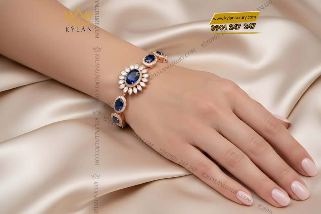 Lắc tay vàng hồng Au750 đính kim cương và đá quý xanh