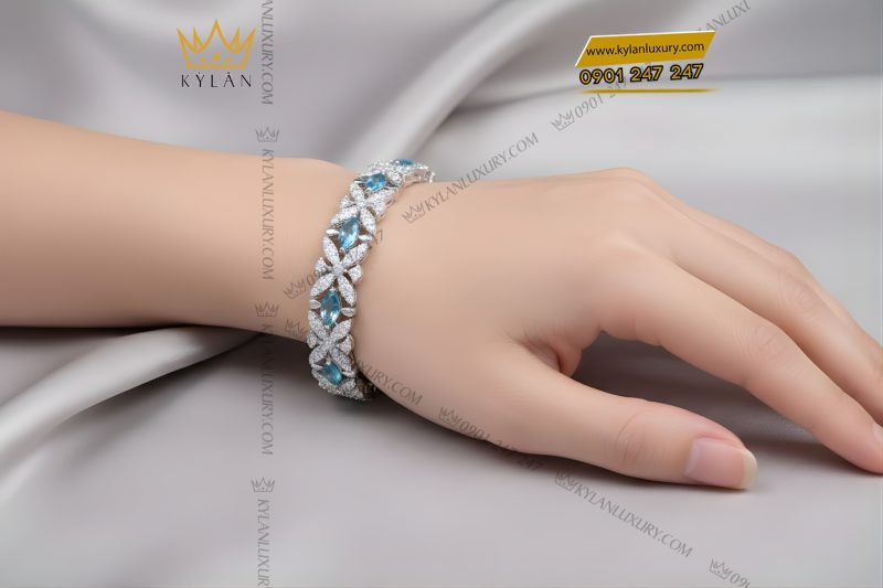 Lắc tay vàng trắng Au750 đính kim cương và đá Topaz