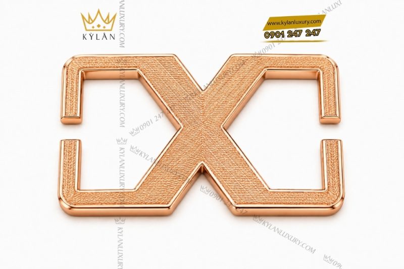 Mặt thắt lưng chữ X vàng hồng Au750 họa tiết vân chéo
